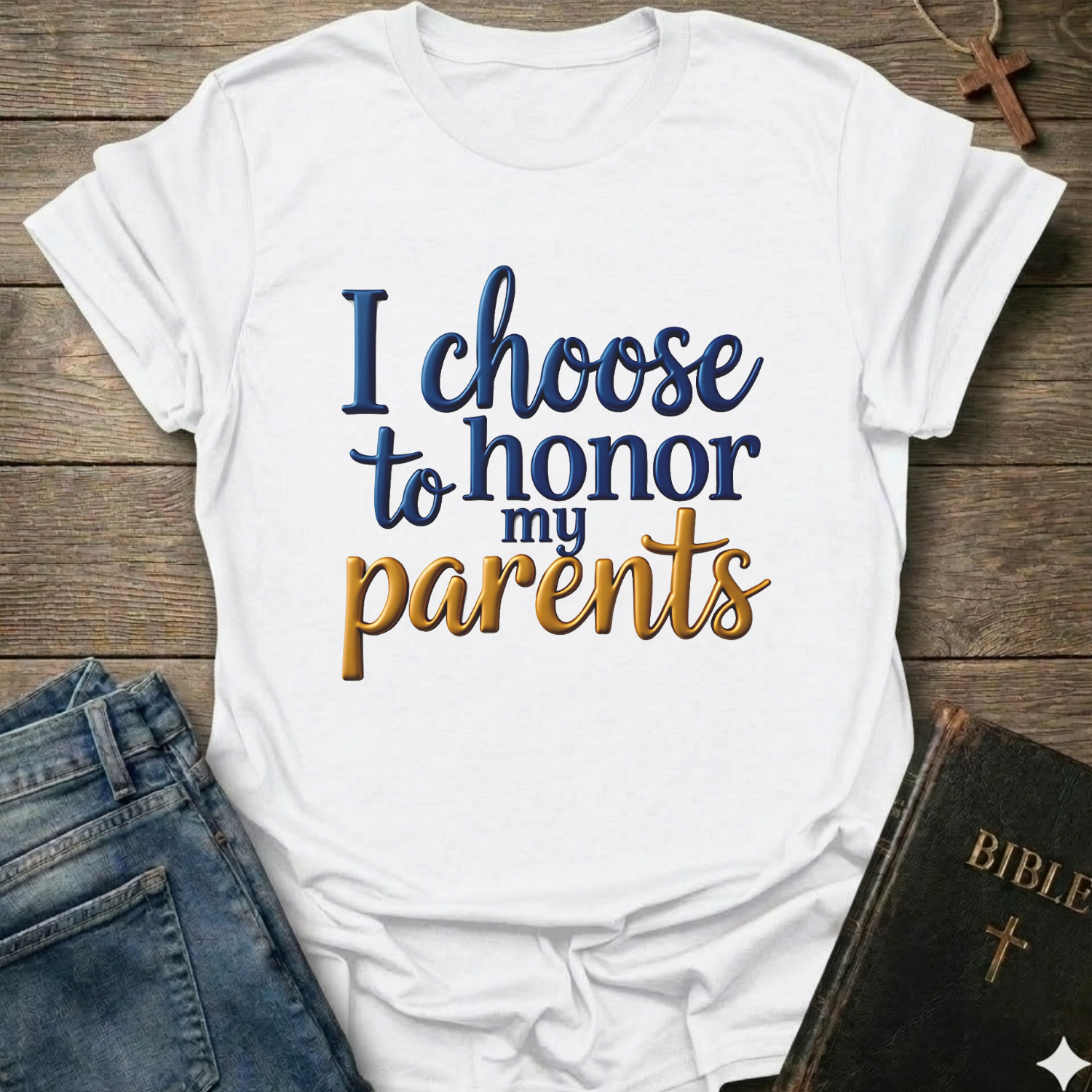 White t-shirt with 'I choose to honor my parents' Exodus 20:12 text navy gold Christian faith apparel conversation starter. T-shirt is on a wooden surface with jeans and a Bible.