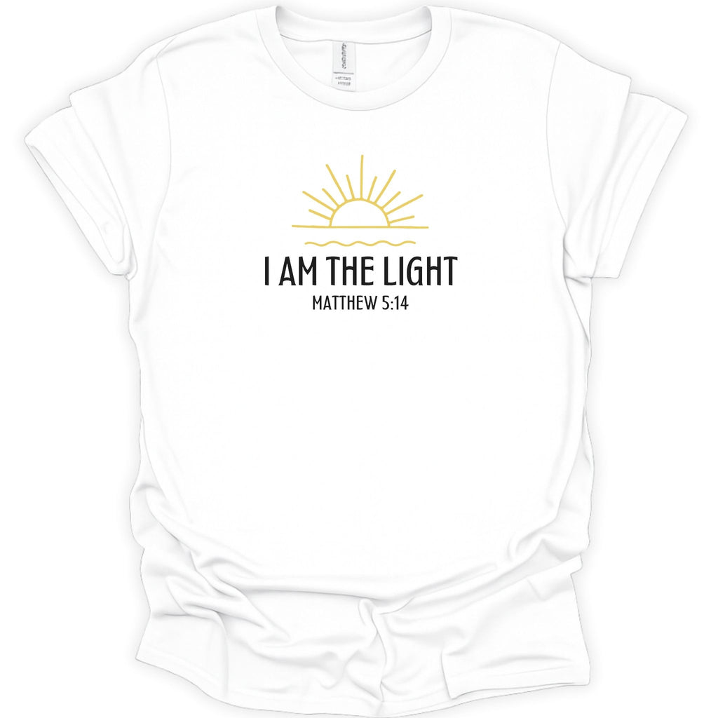 A white short-sleeve crewneck t-shirt with a graphic on the chest featuring a yellow sun and the text 'I AM THE LIGHT MATTHEW 5:14' in black, displayed on a clean white background.