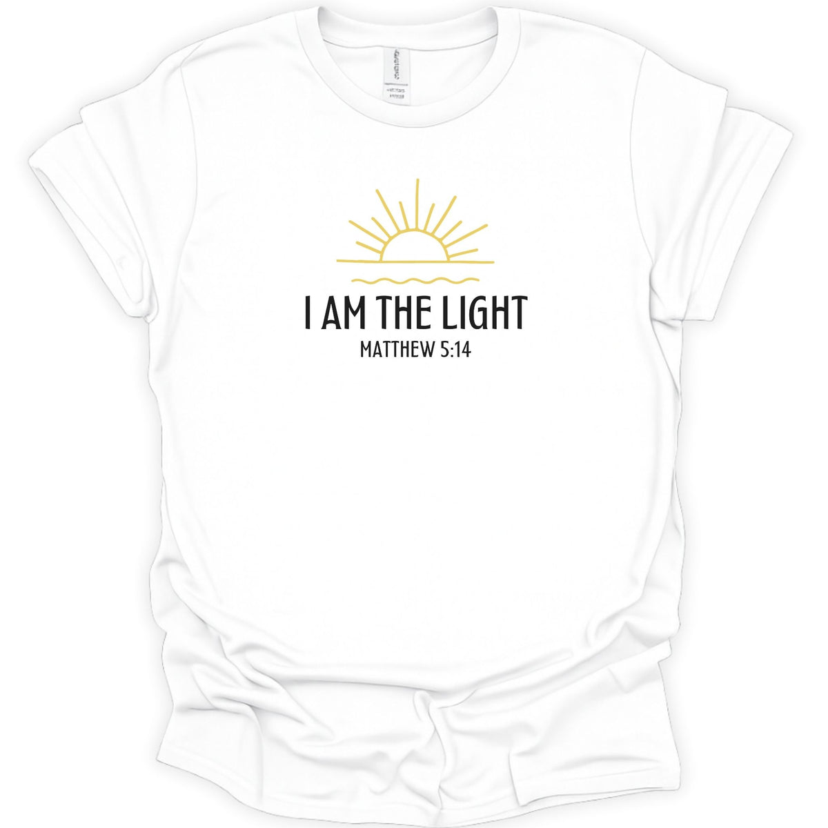 A white short-sleeve crewneck t-shirt with a graphic on the chest featuring a yellow sun and the text 'I AM THE LIGHT MATTHEW 5:14' in black, displayed on a clean white background.