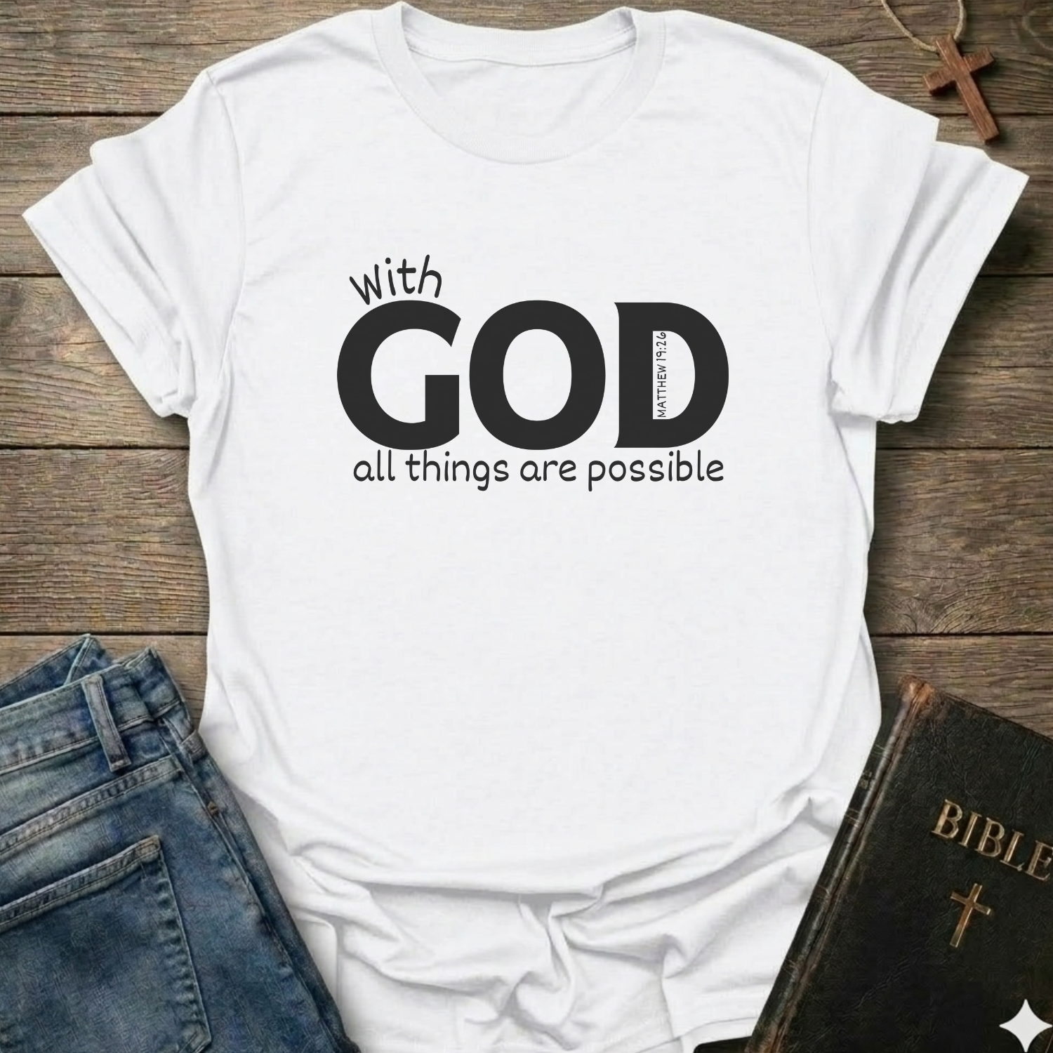 White t-shirt with 'With GOD all things are possible' Matthew 19:26 bold faith apparel conversation starter
text on a wooden surface with jeans and a Bible.