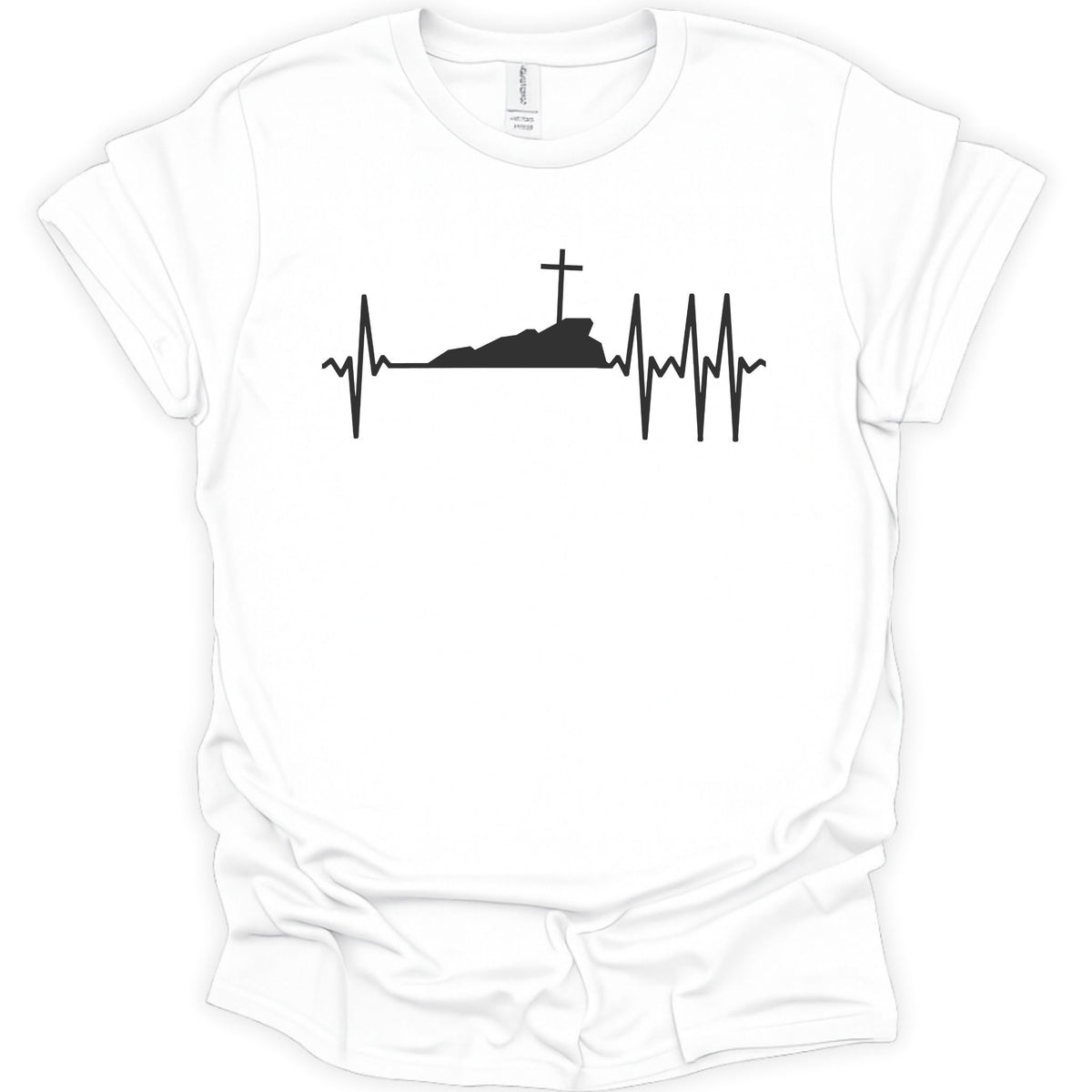 A white short-sleeve crewneck t-shirt with a black graphic print of a heartbeat EKG line forming a cross on a hill and surrounding a silhouette of a tomb.