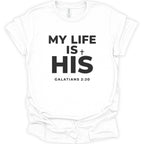 A white short-sleeve crewneck t-shirt with bold black text on the front reading 'MY LIFE IS + HIS' and 'GALATIANS 2:20' underneath, shown on a plain white background.