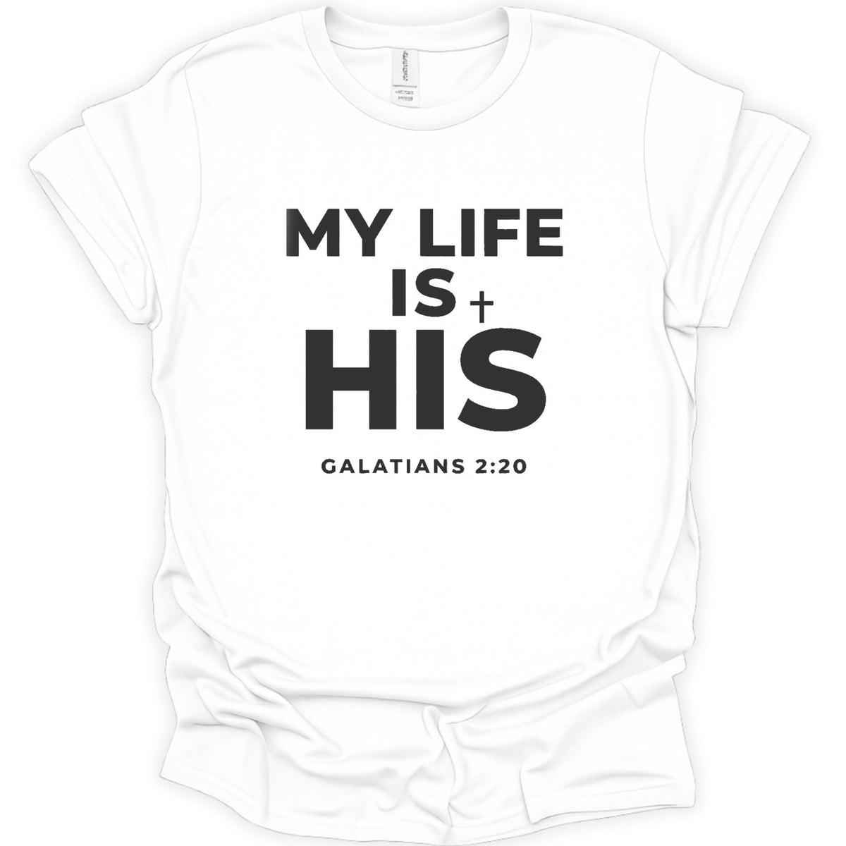 A white short-sleeve crewneck t-shirt with bold black text on the front reading 'MY LIFE IS + HIS' and 'GALATIANS 2:20' underneath, shown on a plain white background.