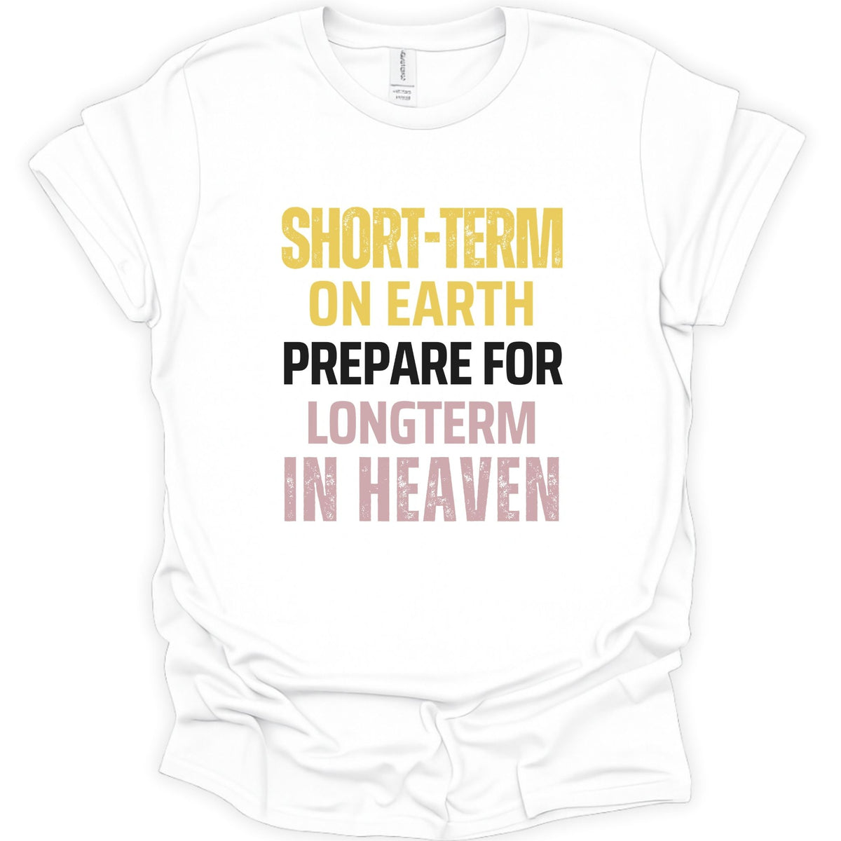 A white short-sleeve t-shirt with a distressed typographic graphic on the front reading 'SHORT-TERM ON EARTH PREPARE FOR LONGTERM IN HEAVEN' in yellow, black, and pink lettering.