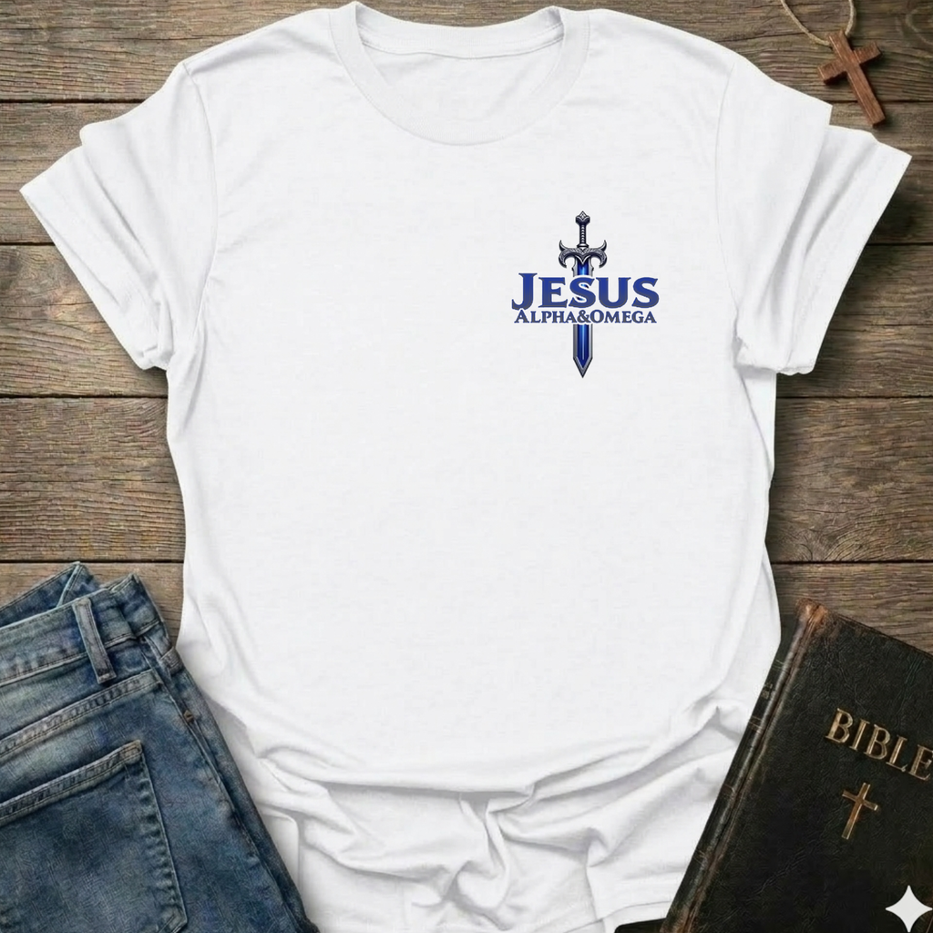 White t-shirt with 'Jesus Alpha & Omega' and a Sword Christian T-Shirt Revelation 22:13 bold faith apparel Faith Forward design on a wooden surface with jeans and a Bible.
