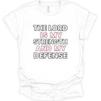 A white short-sleeve crewneck t-shirt with a graphic text print reading 'THE LORD IS MY STRENGTH AND MY DEFENSE' in black and red lettering, displayed flat against a white background.