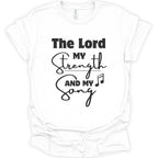 A white short-sleeve crewneck t-shirt with a black graphic text print reading 'The Lord My Strength And My Song' accompanied by a music note symbol, displayed on a clean white background.