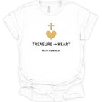 A white short-sleeve crewneck t-shirt with a gold heart and cross graphic above the text 'TREASURE -> HEART' and 'MATTHEW 6:21' printed in black.
