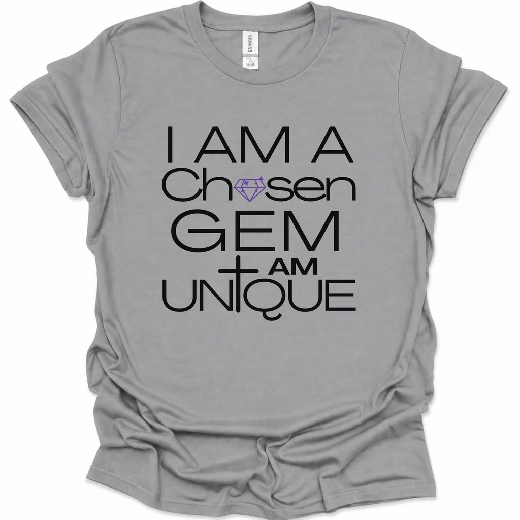 A sport gray short-sleeve t-shirt with a graphic print that reads 'I AM A Chosen GEM I AM UNIQUE' in black lettering, featuring a purple diamond and cross design, displayed on a clean white background.