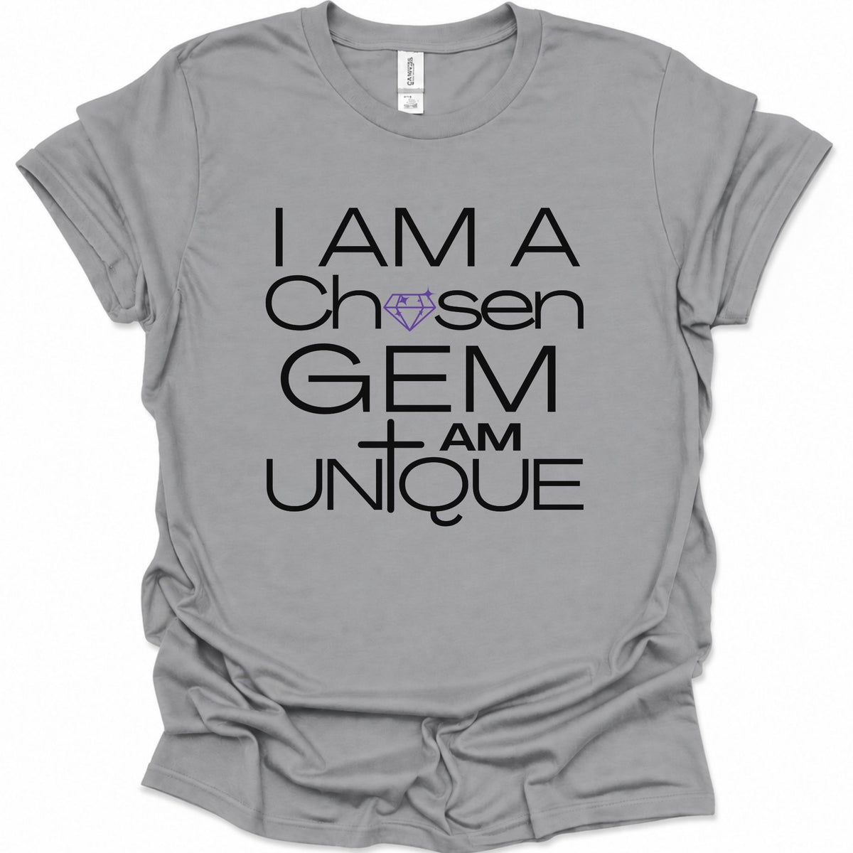 A sport gray short-sleeve t-shirt with a graphic print that reads 'I AM A Chosen GEM I AM UNIQUE' in black lettering, featuring a purple diamond and cross design, displayed on a clean white background.