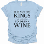 A light blue short-sleeve t-shirt with a black printed text graphic reading 'IT IS NOT FOR KINGS it is not for kings TO DRINK WINE' on a white background.