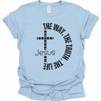 A light blue short-sleeve t-shirt with a black graphic print on the front featuring a cross, the word 'Jesus', and the phrase 'THE WAY, THE TRUTH, THE LIFE' curved around it.