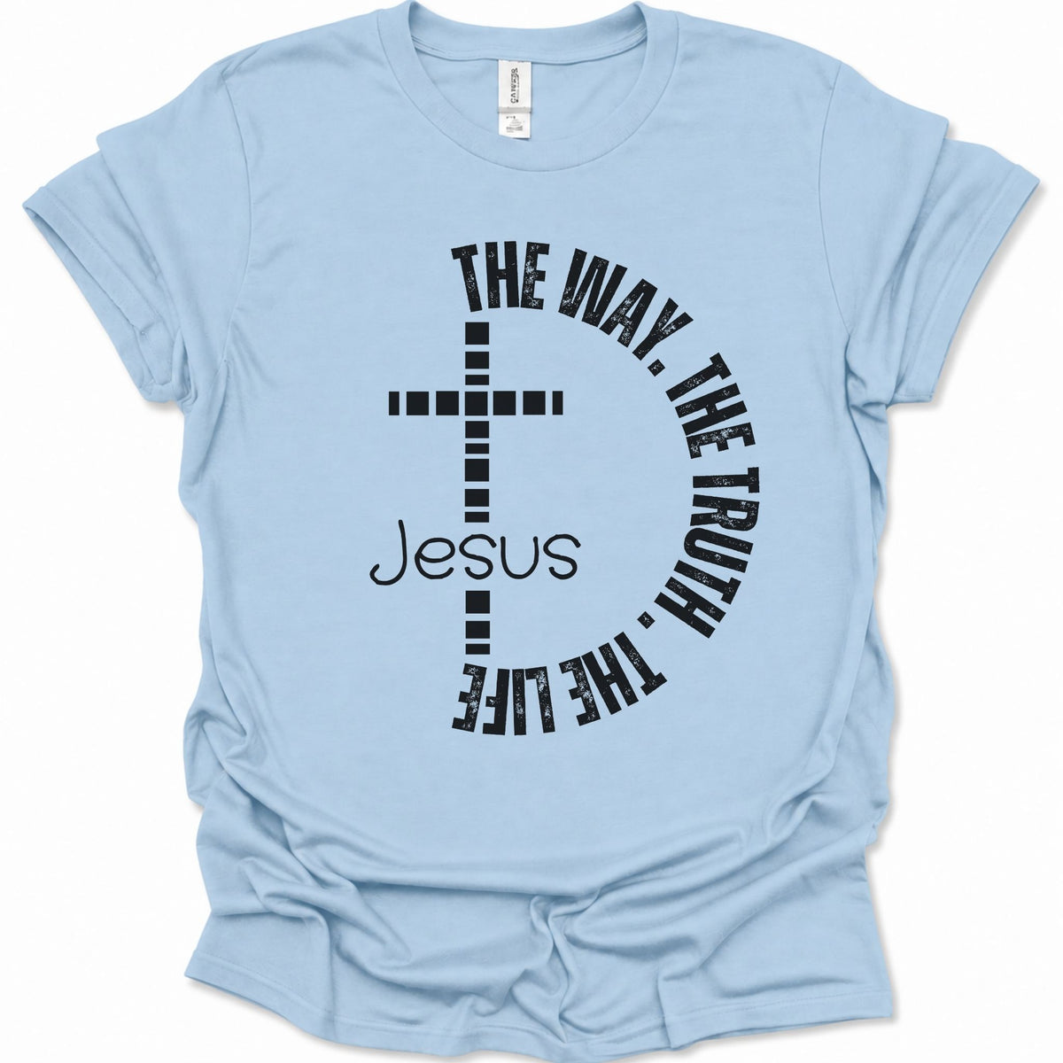 A light blue short-sleeve t-shirt with a black graphic print on the front featuring a cross, the word 'Jesus', and the phrase 'THE WAY, THE TRUTH, THE LIFE' curved around it.