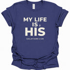 A purple blue short-sleeve t-shirt with white printed text reading 'MY LIFE IS HIS' and 'GALATIANS 2:20' on the front, shown on a plain white background.
