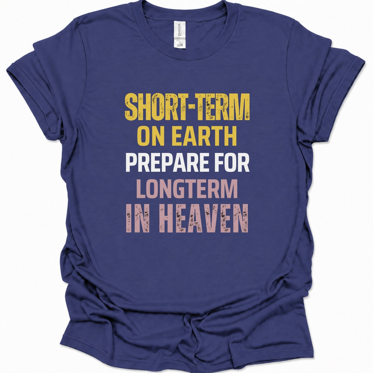 A purple blue short-sleeve t-shirt with a distressed typographic graphic on the front reading 'SHORT-TERM ON EARTH PREPARE FOR LONGTERM IN HEAVEN' in yellow, white, and pink lettering.