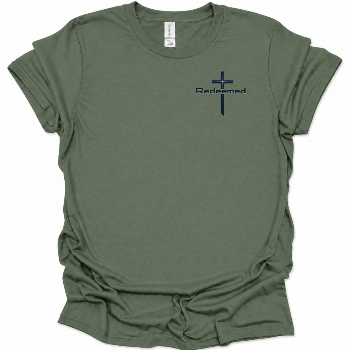 A military green short-sleeve t-shirt with a small navy blue cross and the word 'Redeemed' printed on the left chest, displayed on a clean white background.