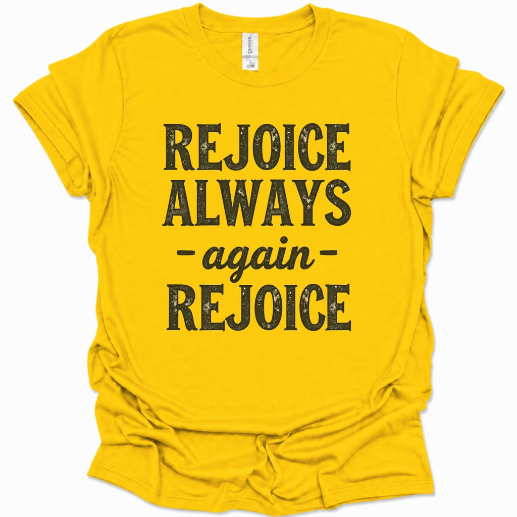 A daisy yellow short-sleeve t-shirt with a distressed black graphic print that reads 'REJOICE ALWAYS - again - REJOICE' on the front, displayed against a clean white background.