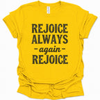 A daisy yellow short-sleeve t-shirt with a distressed black graphic print that reads 'REJOICE ALWAYS - again - REJOICE' on the front, displayed against a clean white background.