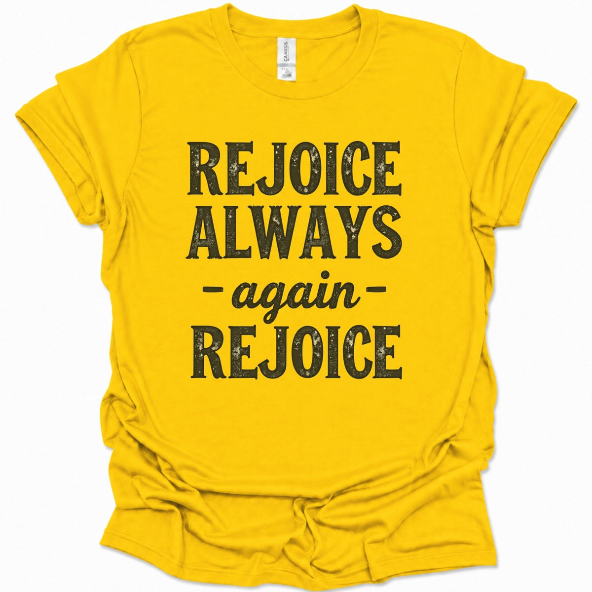 A daisy yellow short-sleeve t-shirt with a distressed black graphic print that reads 'REJOICE ALWAYS - again - REJOICE' on the front, displayed against a clean white background.