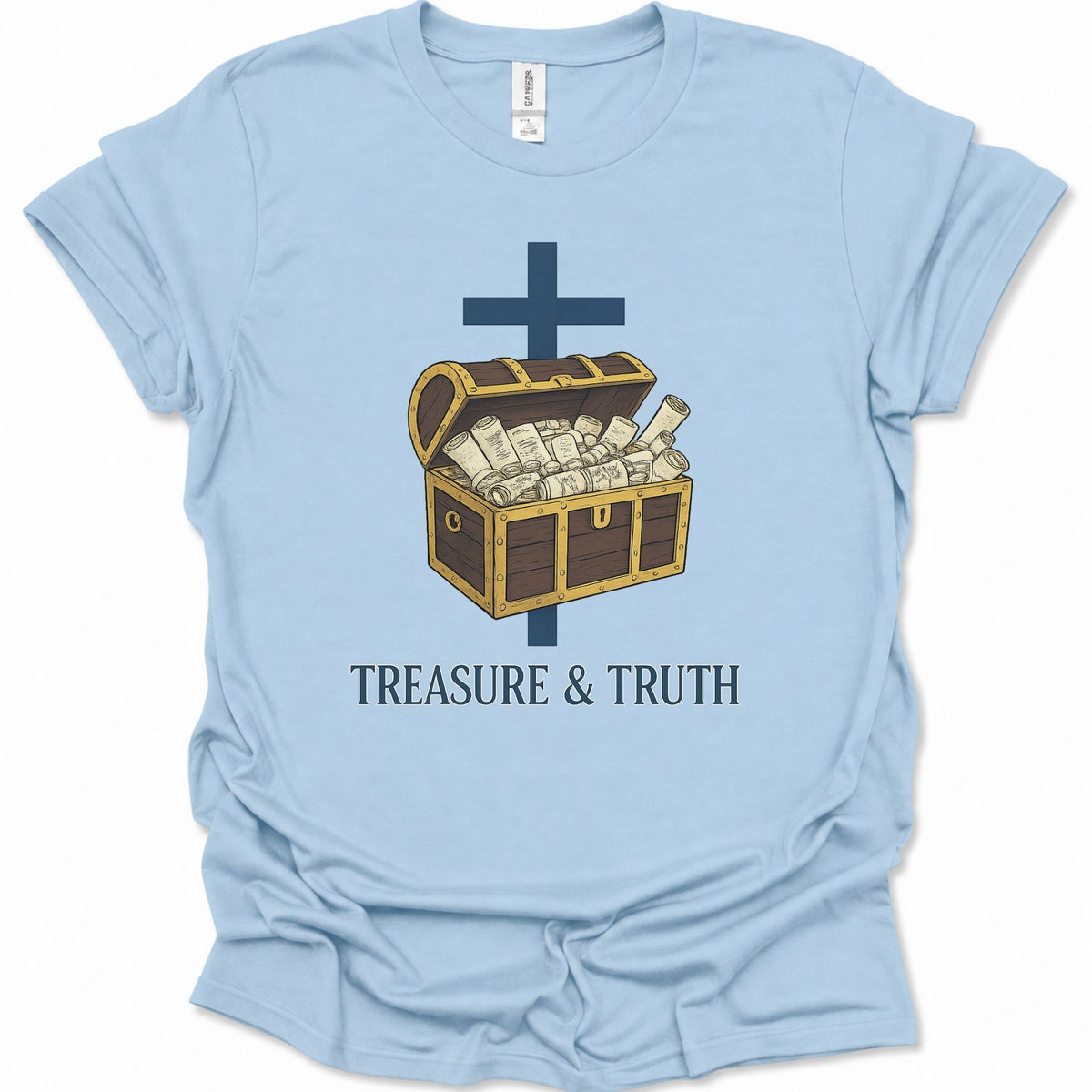 A light blue short-sleeve t-shirt with a graphic of an open treasure chest filled with cash, overlaid with a dark blue cross, and the text 'TREASURE & TRUTH' printed below.
