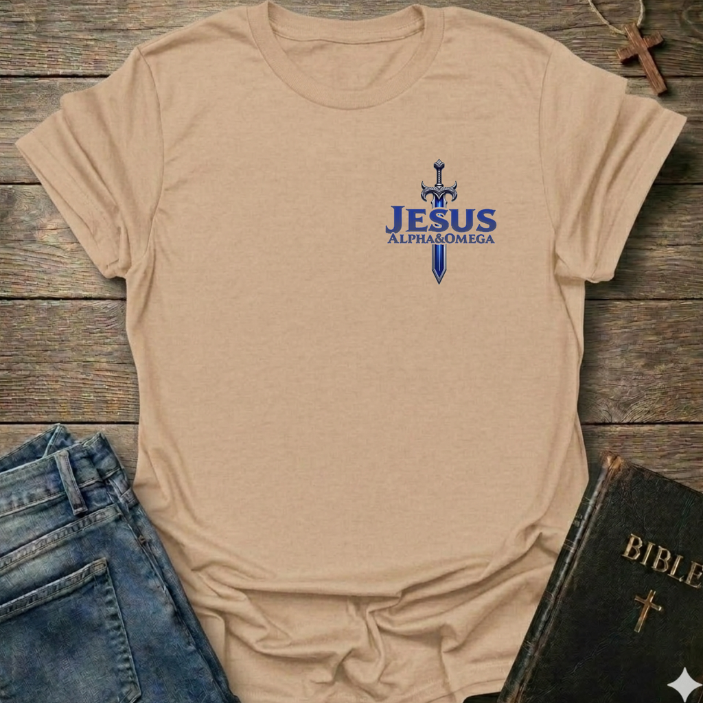 Natural t-shirt with 'Jesus Alpha & Omega' and a Sword Christian T-Shirt Revelation 22:13 bold faith apparel Faith Forward design on a wooden surface with jeans and a Bible.
