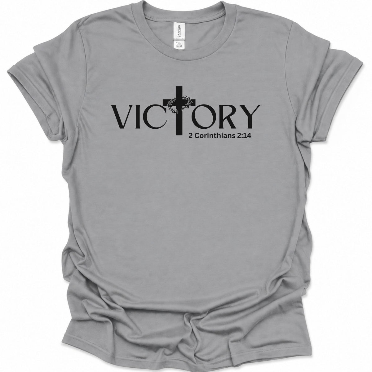 A sport gray short-sleeve t-shirt with a black graphic print on the front reading 'VICTORY' with a cross and '2 Corinthians 2:14' underneath, shown on a plain white background.