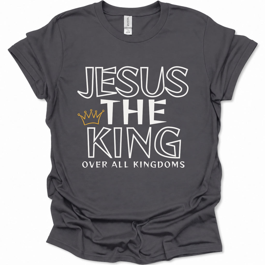 A dark heather gray short-sleeve t-shirt with a graphic print that reads 'JESUS THE KING OVER ALL KINGDOMS' in white outline lettering, accented by a small gold crown icon, shown on a plain white background.