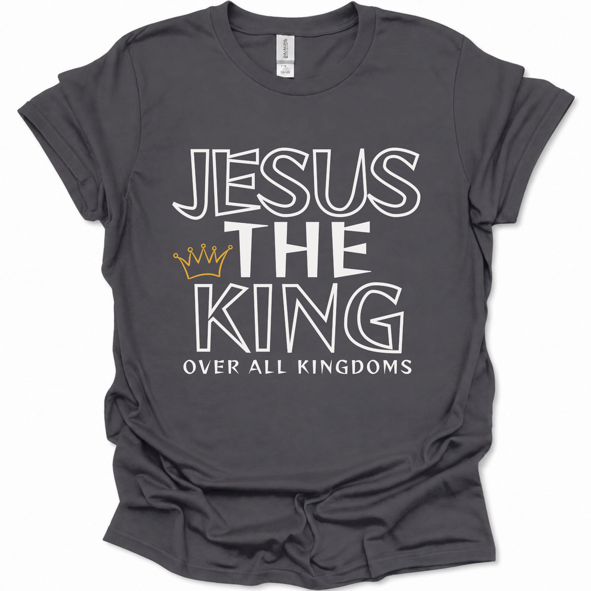 A dark heather gray short-sleeve t-shirt with a graphic print that reads 'JESUS THE KING OVER ALL KINGDOMS' in white outline lettering, accented by a small gold crown icon, shown on a plain white background.