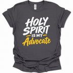 A dark heather gray short-sleeve t-shirt with a graphic print that reads 'HOLY SPIRIT IS MY Advocate' in white and yellow lettering, displayed on a clean white background.