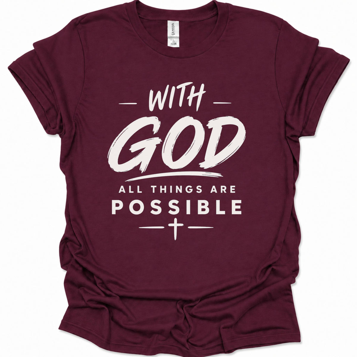 A maroon short-sleeve crewneck t-shirt with a white graphic text print reading 'WITH GOD ALL THINGS ARE POSSIBLE' and a cross symbol, shown on a plain white background.