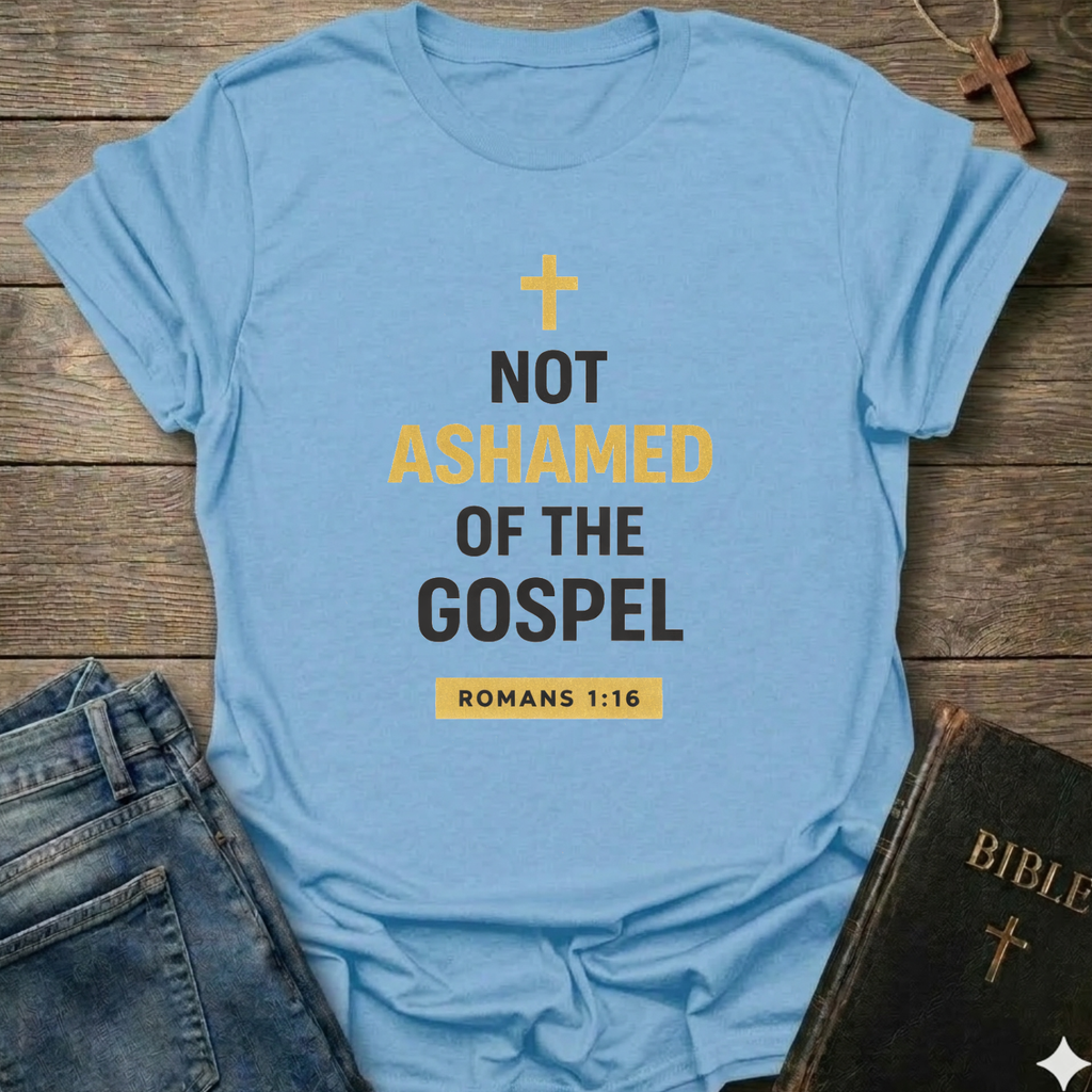Light blue t-shirt with 'Not Ashamed of the Gospel' text on a wooden surface with a Bible and cross. Christian T-Shirt Romans 1:16 bold faith apparel Faith Forward