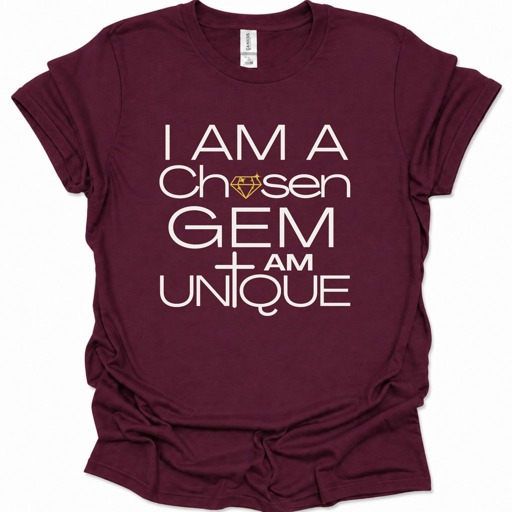 A maroon short-sleeve t-shirt with a white graphic text print reading 'I AM A Chosen GEM I AM UNIQUE' and a small gold diamond icon, shown on a plain white background.