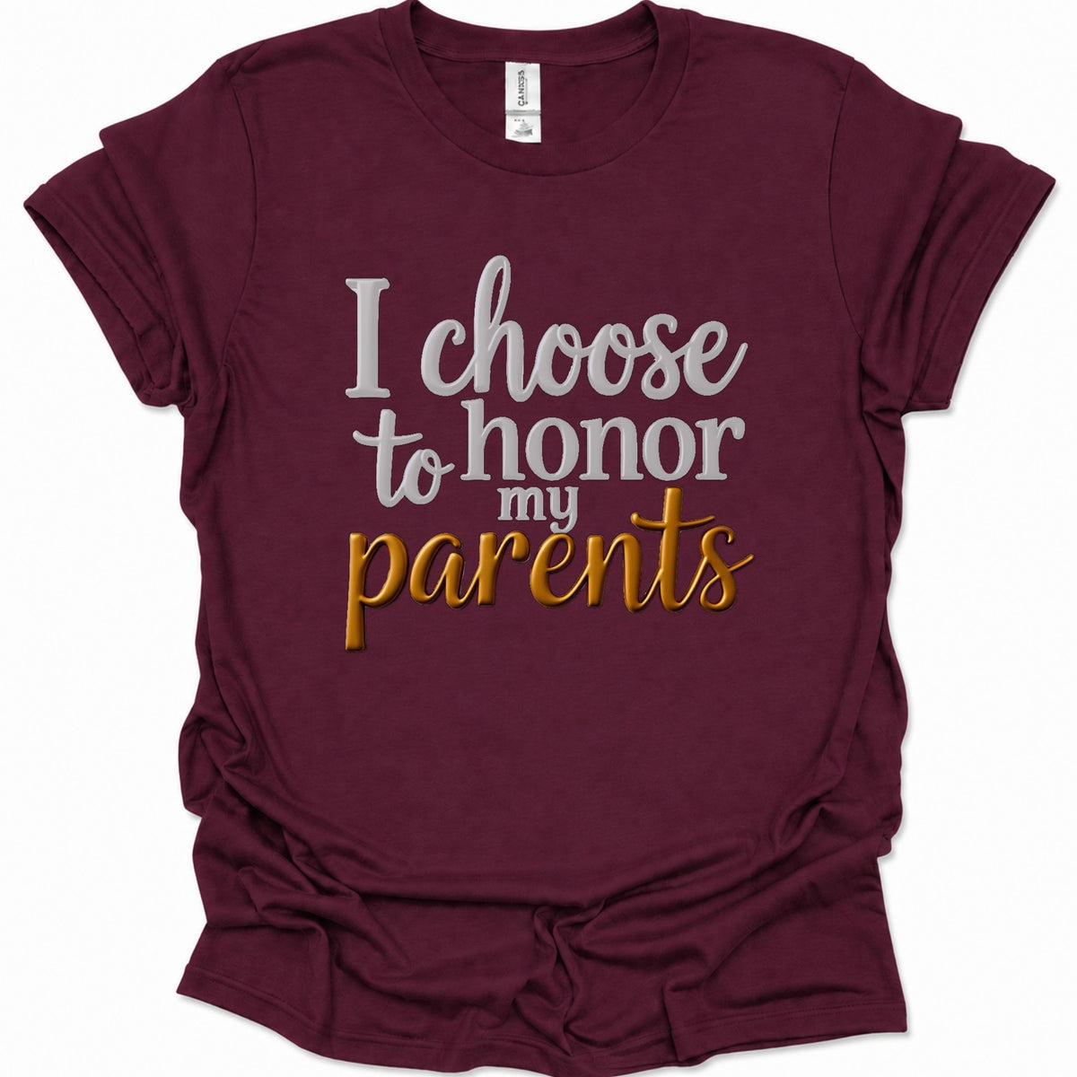 A maroon short-sleeve t-shirt with a graphic text print reading 'I choose to honor my parents' in white and gold lettering, displayed on a clean white background.