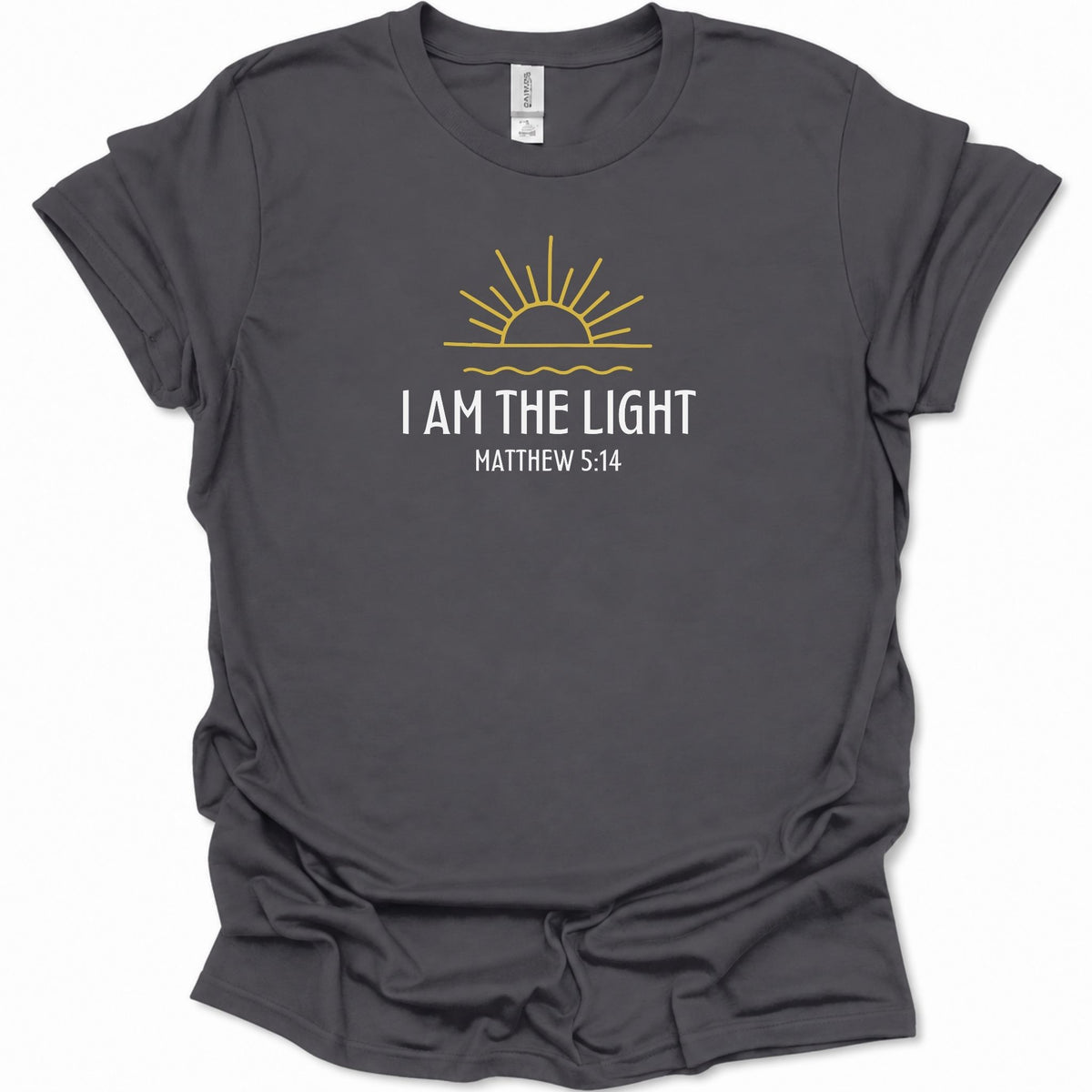 A dark heather gray short-sleeve t-shirt with a graphic print of a yellow rising sun and the text 'I AM THE LIGHT MATTHEW 5:14' in white and yellow, displayed on a clean white background.