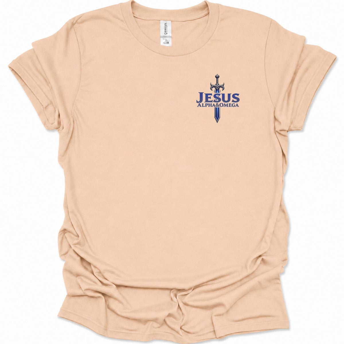 A light natural-colored short-sleeve t-shirt with a blue graphic on the left chest featuring a sword and the text  'JESUS ALPHA & OMEGA' in dark blue. The shirt is shown flat against a white background.