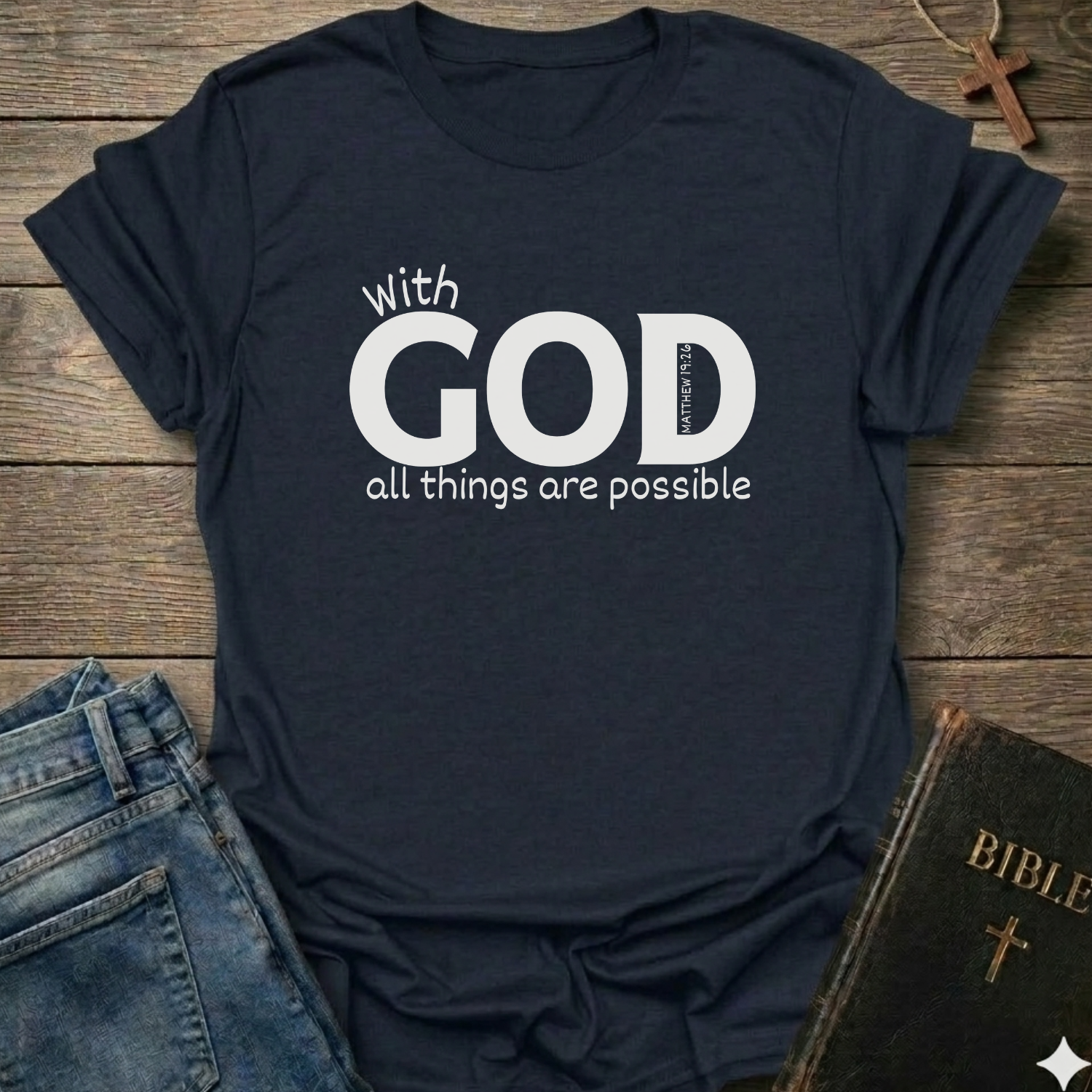 Navy blue t-shirt with 'With GOD all things are possible' Matthew 19:26 bold faith apparel conversation starter
text on a wooden surface with jeans and a Bible.