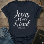 Navy blue t-shirt with 'Jesus is my friend' text on a wooden surface with jeans and a Bible. Jesus is My Friend Christian T-Shirt John 15:14 bold faith apparel Faith Forward