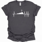 A dark heather gray short-sleeve t-shirt with a white graphic print of a cross on top of a hill, integrated into an EKG heartbeat line, shown on a plain white background.