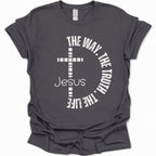 A dark gray short-sleeve t-shirt with a white graphic print on the front featuring a cross, the word 'Jesus', and the phrase 'THE WAY, THE TRUTH, THE LIFE' arranged in a circle.