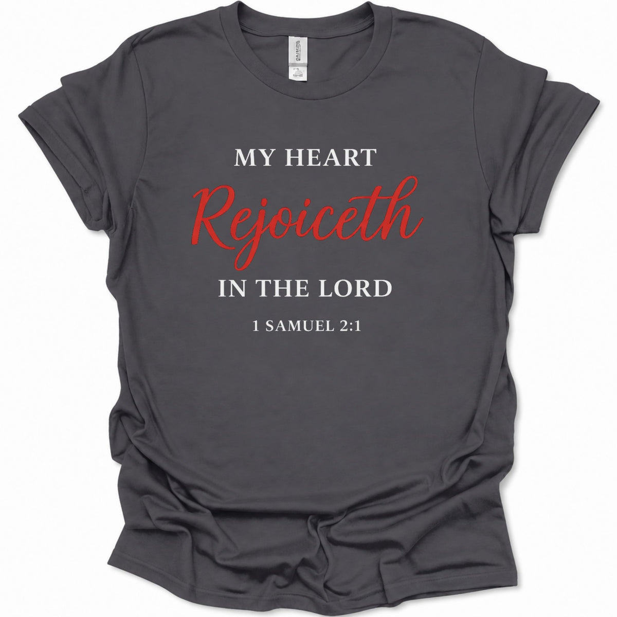 A dark heather gray short-sleeve t-shirt with a printed religious quote on the front reading 'MY HEART Rejoiceth IN THE LORD 1 SAMUEL 2:1' in white and red lettering, shown against a plain white background.