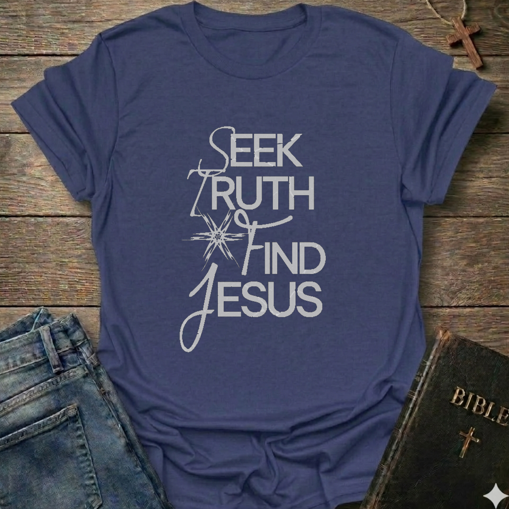 Purple t-shirt with 'Seek Truth Find Jesus' text on a wooden surface with jeans and a Bible. Bold typography faith apparel conversation starter.