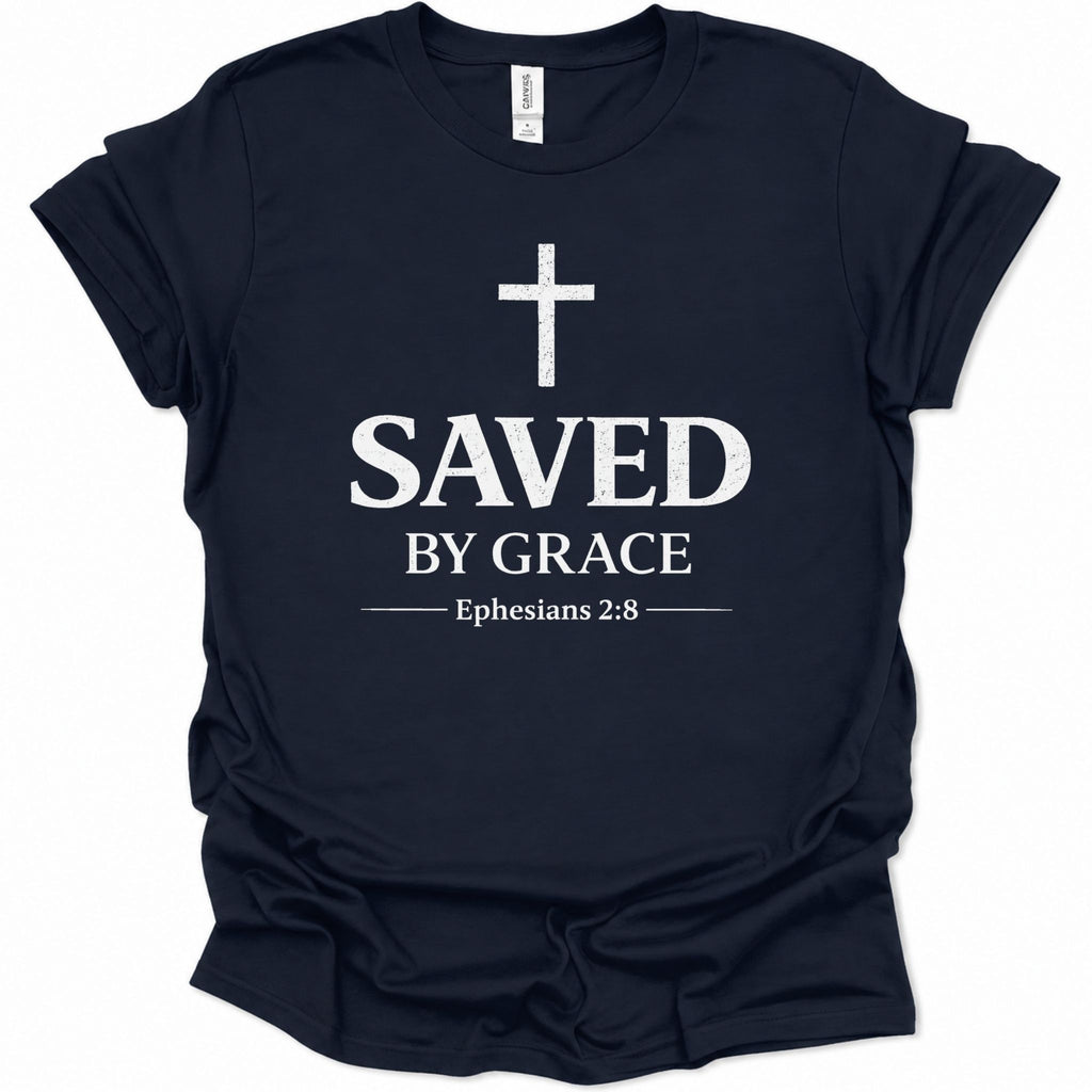 A navy blue short-sleeve t-shirt with a white graphic print on the front featuring a cross, the text 'SAVED BY GRACE', and 'Ephesians 2:8'.
