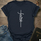 Navy blue t-shirt with 'faith' design on a wooden surface with jeans and a Bible. Faith Minimalist Cross Script Christian T-Shirt bold faith apparel Faith Forward