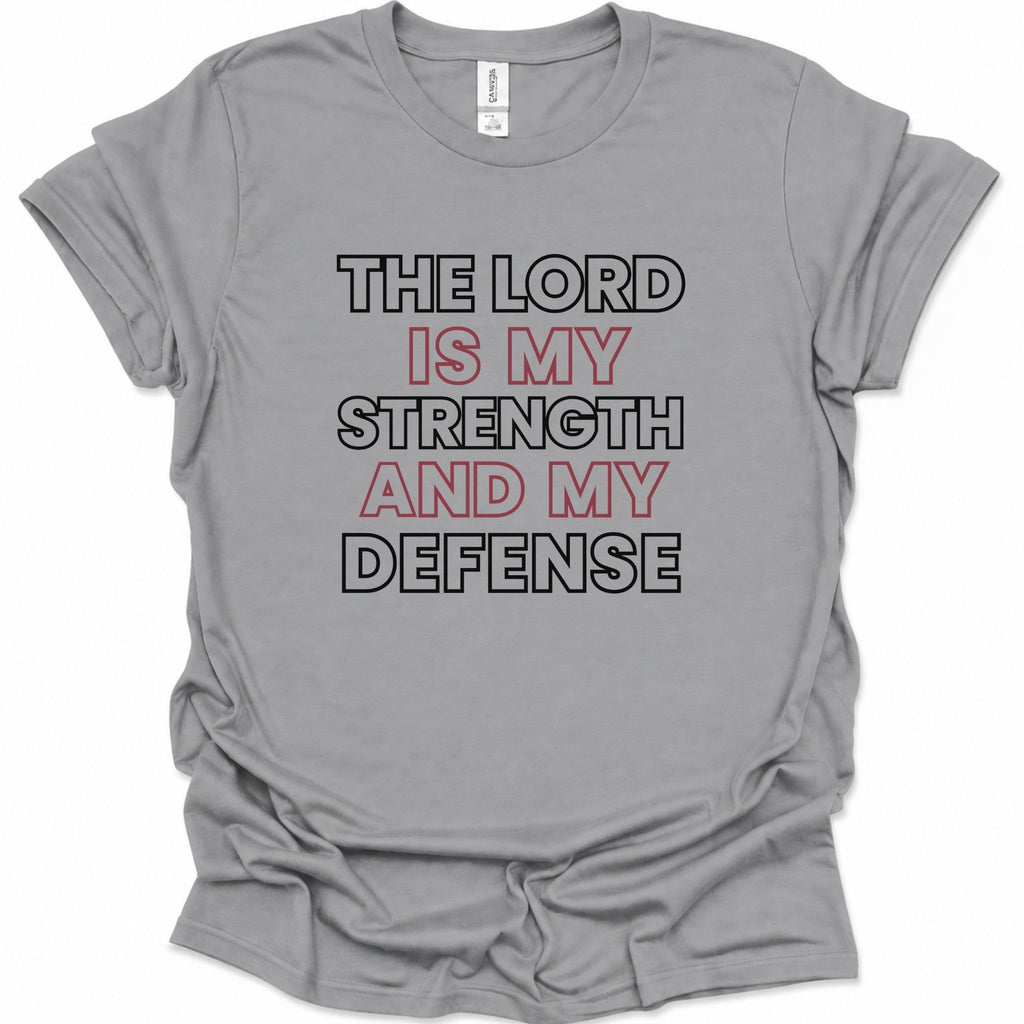 A sport gray short-sleeve crewneck t-shirt with a graphic text print reading 'THE LORD IS MY STRENGTH AND MY DEFENSE' in black and red lettering, laid flat on a white background.