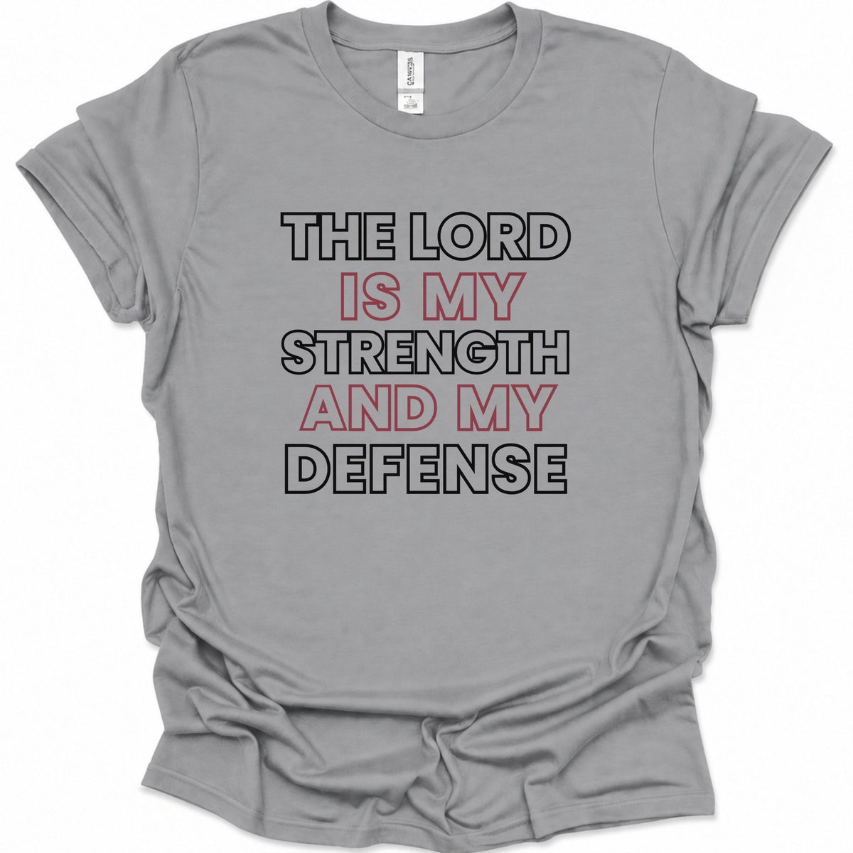 A sport gray short-sleeve crewneck t-shirt with a graphic text print reading 'THE LORD IS MY STRENGTH AND MY DEFENSE' in black and red lettering, laid flat on a white background.