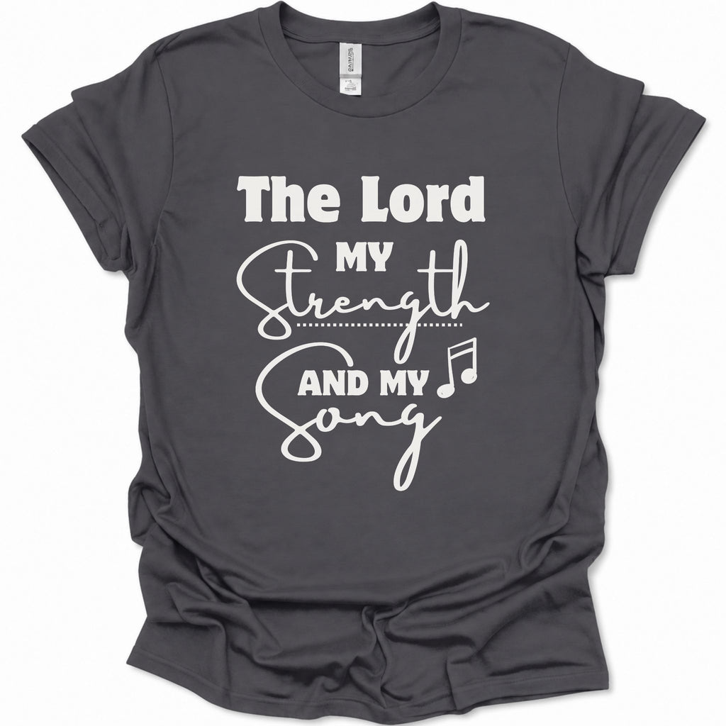A dark heather gray short-sleeve t-shirt with a white graphic print that reads 'The Lord My Strength And My Song' with a music note, displayed on a clean white background.