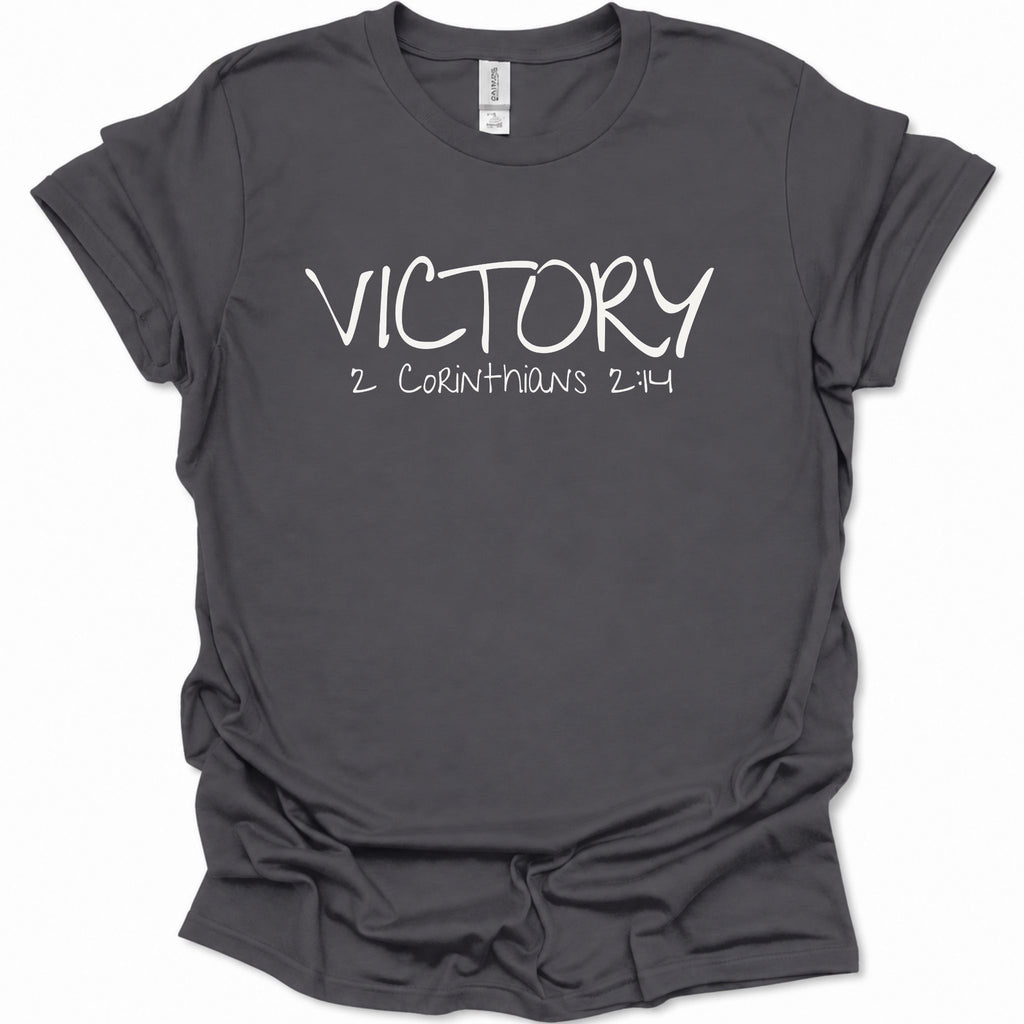 A dark heather gray short-sleeve t-shirt with 'VICTORY 2 CORINTHIANS 2:14' printed in white across the chest, displayed on a clean white background.