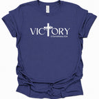 A purple blue short-sleeve t-shirt with a white graphic print on the front reading 'VICTORY' with a Christian cross replacing the letter 'I' and '2 Corinthians 2:14' beneath a cross design.