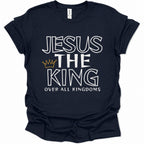 A navy blue short-sleeve t-shirt with a graphic print reading 'JESUS THE KING OVER ALL KINGDOMS' in white outlined lettering, accented by a small gold crown icon, shown on a plain white background.