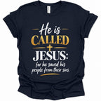 A navy blue short-sleeve t-shirt with a graphic print on the front that reads 'He is CALLED JESUS: for he saved his people from their sins.' in white and gold lettering, displayed on a clean white background.